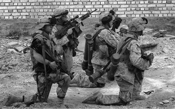 Marines from Charlie Company, 3d Battalion, Regimental Combat Team 7, provide security while a mortar team fires on enemy positions during Operation Al-Fajr, 12 November 2004.